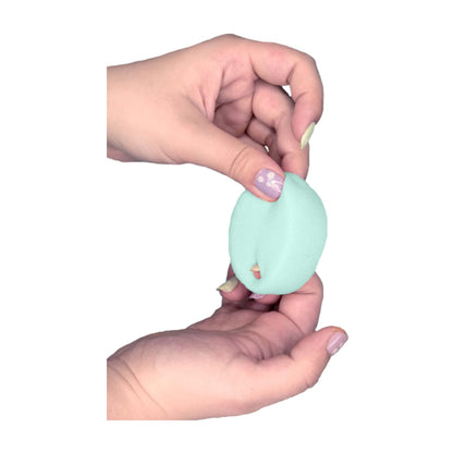 Menstrual sponge held in two hands showing retrieval loop