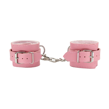 Close-up of pink faux fur hand cuffs showing buckle fittings 