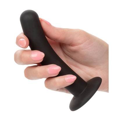 Curved silicone dildo shown held comfortably in hand 
