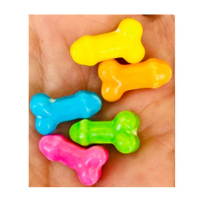 Dick-shaped candies close up in hand out of packaging
