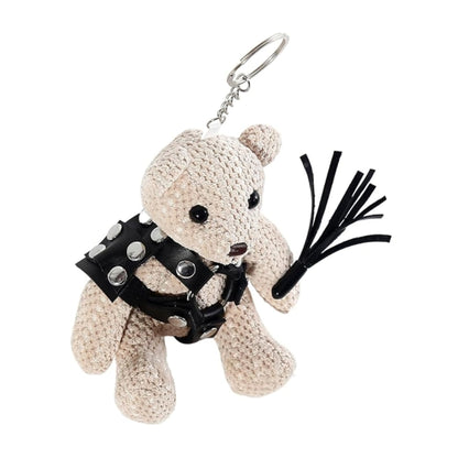 Side view of teddy bear keychain holding mini flogger