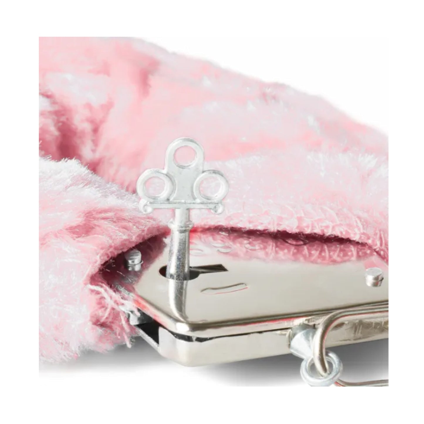 Close-up of handcuff key beside pink plush cuff