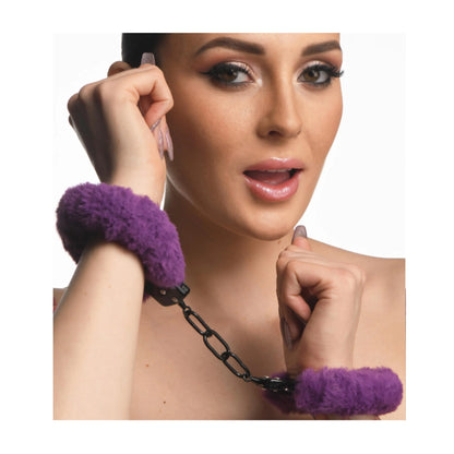 Model wearing purple faux fur handcuffs connected by chain