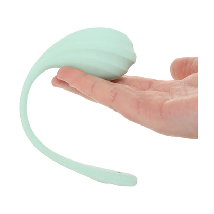 Wearable vibrator shown on fingers to demonstrate compact size