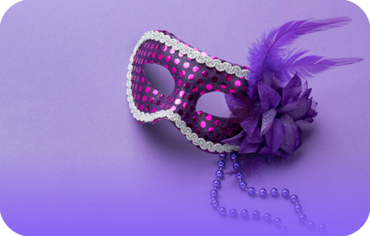 Purple masquerade mask with pink polka dots and feathers on a purple background